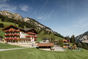 a large building in the middle of a mountain at Berghotel Alpenklang in Grossarl