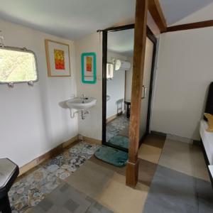 a bathroom with a sink and a mirror at Omah Singo Stay and Resto in Bantul