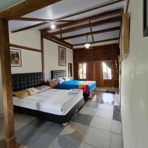 a bedroom with two beds in a room at Omah Singo Stay and Resto in Bantul