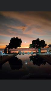 a reflection of two trees in a body of water at Lanta Garden Home in Ko Lanta