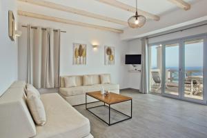 a living room with a couch and a table at Anatoli Villas in Amoopi