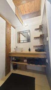 a bathroom with a sink and a mirror at Beau T3 au cœur du centre ville in Narbonne