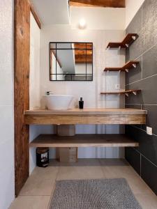 a bathroom with a sink and a mirror at Beau T3 au cœur du centre ville in Narbonne