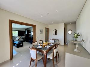 Un comedor y una sala de estar con mesa y sillas. en Quarteira Classic 1 With Pool by Homing, en Quarteira