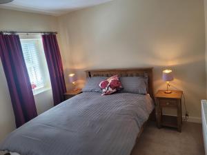a bedroom with a large bed with two night stands at Stoneyford Village in Stonyford
