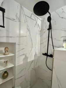a bathroom with a shower with white marble walls at Nouveau Loft: vieille-ville, musée Picasso, marché in Antibes