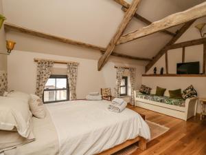 a bedroom with a large white bed and a window at Pen Bont Home Farm in Brecon