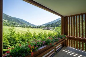 a balcony with a view of a field and mountains at Hotel OTP Birkenhof in Bad Kleinkirchheim