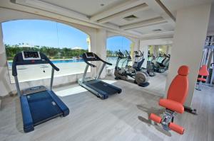 a gym with several treadmills and elliptical machines at Tropitel Sahl Hasheesh in Hurghada