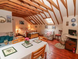 a large living room with a bed and a table at Ryan's Loft in Ardfinnan