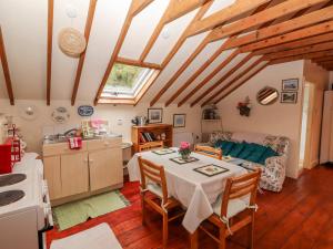 a kitchen and living room with a table and chairs at Ryan's Loft in Ardfinnan