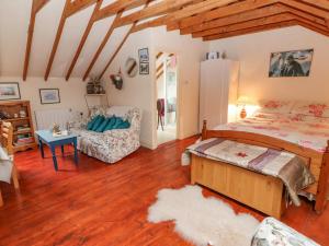 a bedroom with a bed and a living room at Ryan's Loft in Ardfinnan