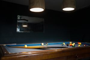 a pool table with billiard balls on top of it at Un petit bout du monde in Saint-Georges-en-Couzan