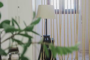 a lamp sitting in a room with a plant at Minimal Culture Boutique hotel in Kavala