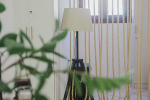 a lamp sitting in a room with a plant at Minimal Culture Boutique Rooms in Kavála +162 photos