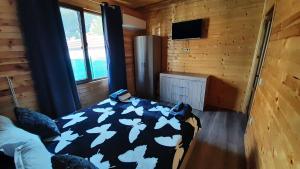 ein Schlafzimmer mit einem Bett mit weißen Schmetterlingen darauf in der Unterkunft Вила ВлаиДа in Saparewa Banja