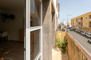 a building with a balcony with a view of a street at Casablanca House in Corralejo