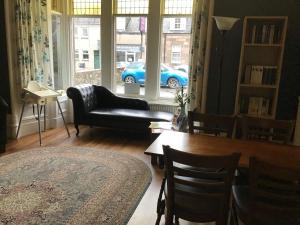 a living room with a couch and a blue car in the window at Belvedere Guest House in Stonehaven