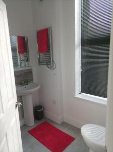 a white bathroom with a sink and a toilet at Victorian Renovation Room 3 in Liverpool