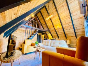 a living room with a couch and a staircase at Garden Bungalow in Antalya