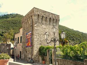 a stone building with a street light in front of it at A casa di Oscar in Deiva Marina