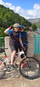 拉努西亞的住宿－Caravana- Glamping Casa tortuga，两个人骑着自行车在桥上