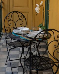 a table with two chairs and plates on it at La Casa di Andre in Sanremo