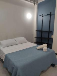 a bedroom with a bed with two towels on it at Hotel Family House Rodadero in Santa Marta