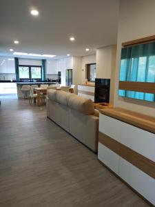 a living room with a large couch and a kitchen at Casa da Falperra in Arcos de Valdevez