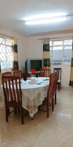 a dining room with a table and four chairs at Adorable 2bedroom homestay in Beau Bassin