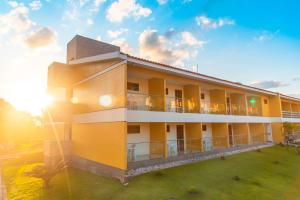 a building with the sun setting behind it at Bonito Plaza Hotel in Bonito