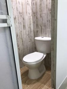 a bathroom with a white toilet in a room at Casa 39-37 in Cartagena de Indias