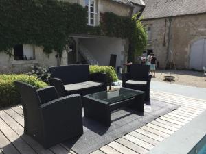 un grupo de sillas y una mesa de centro en un patio en VILLA MARLISE Chambre Hôtes, en Saint-Satur