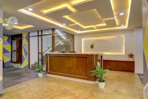 an office lobby with a reception desk and plants at Destino By INR Suites in Hyderabad