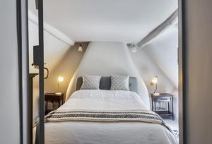 a bedroom with a white bed with two pillows at Hilltop Cottage in Chalbury