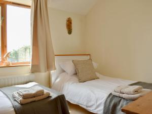 a bedroom with two beds and a window at Grange Court in Cliburn