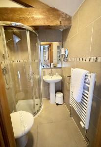 a bathroom with a shower toilet and a sink at Sheldon Cottage in Buxton +36 photos