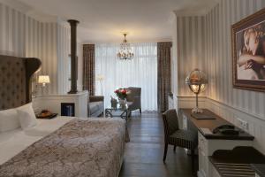 a hotel room with a bed and a desk and a bedroom at Europa Hotel Kühlungsborn in Kühlungsborn +37 photos
