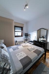 - une chambre avec un lit, une commode et un miroir dans l'établissement Maria's Apartment, à Porto