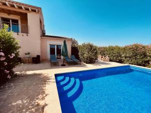 a villa with a swimming pool in front of a house at CASA Luz Solar - Finca mit privatem Pool nahe Strand & Santanyí in Cala Santanyi +37 photos