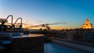 a view of the sunset from the roof of a building at Hotel Banovani in Tbilisi City