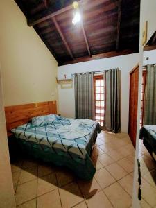 a bedroom with a bed and a window in it at Pousada Clara Manhã in Bombinhas