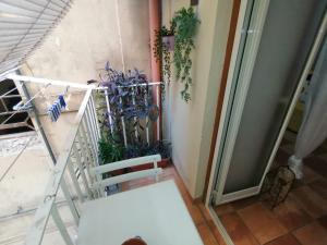 una silla blanca en un balcón con una planta en Blanco's home, en Nápoles