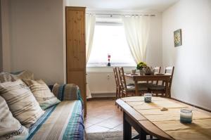 a living room with a couch and a table at Neue Reihe 8 Wohnung links in Cuxhaven