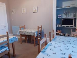 a room with a table and chairs and a dining room at Bank House in Thurso