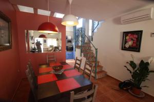 a dining room with a table and chairs and a staircase at Dar Saioa in Torrevieja