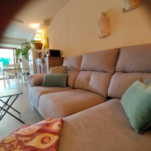 a living room with a brown couch and a table at Casa Francesca Altea piscina y aparcamiento privado in Altea