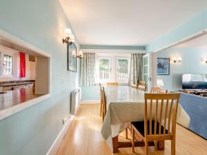 a dining room and living room with a table and chairs at Advantage Point in West Lulworth