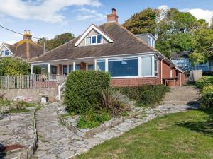 a home with a brick house with a large window at Advantage Point in West Lulworth