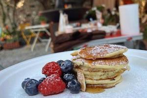 a plate with a stack of pancakes and berries at Villa Clelia in Levanto